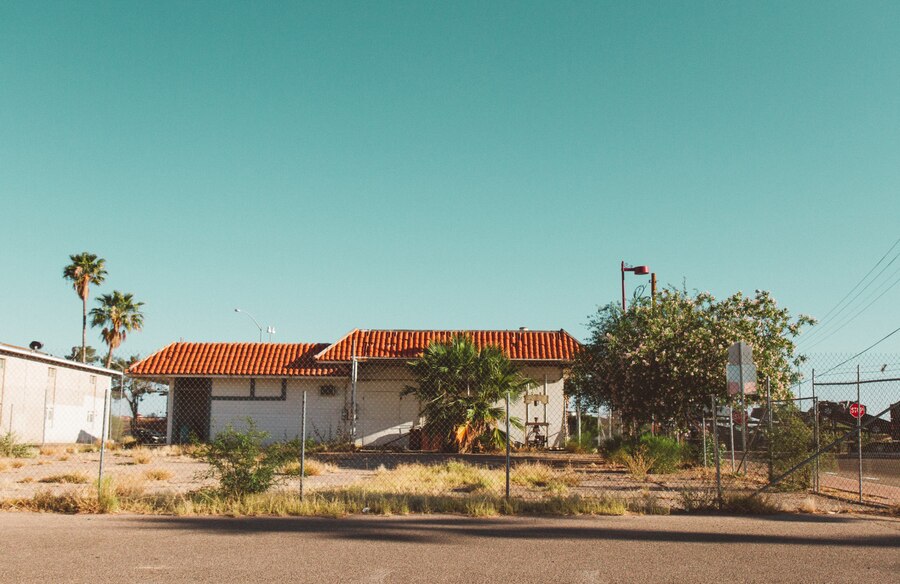 house-with-fence-around-it-with-clear-sky